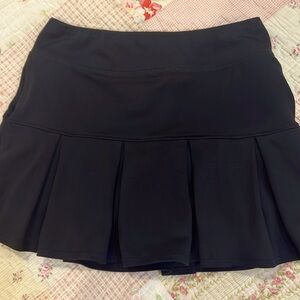 Freely black medium tennis skirt with pockets and built in shorts.